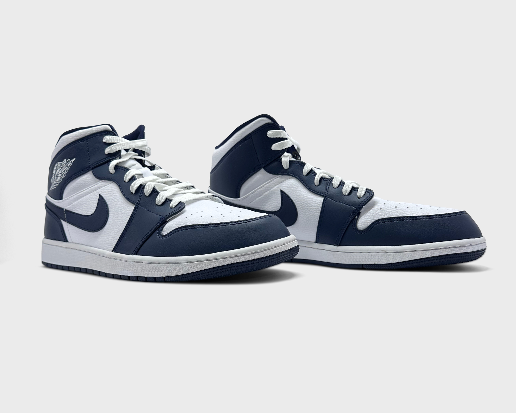 Jordan 1 Mid Obsidian Sneaker blau weiß Paar schräg von vorne
