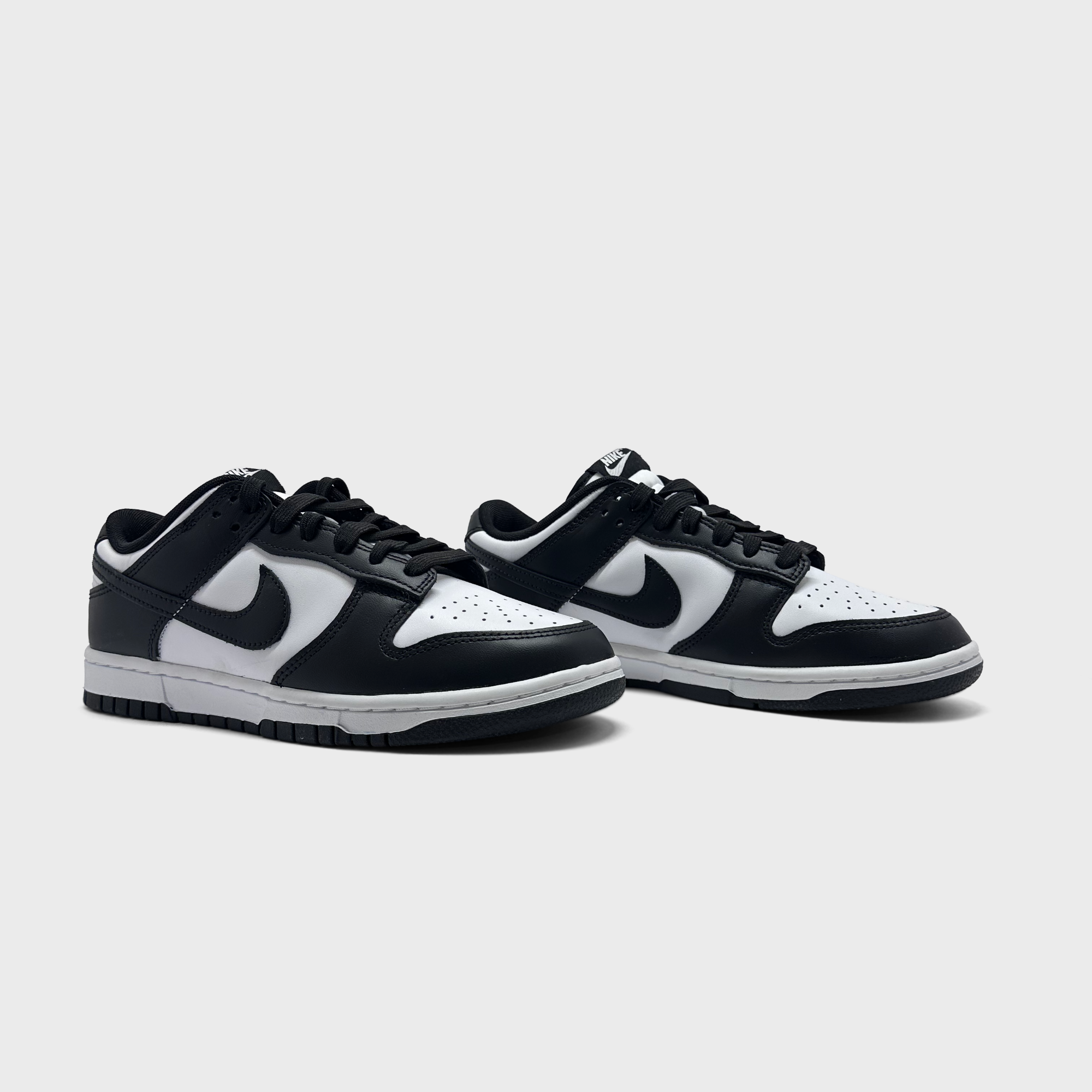 Nike Dunk Low Panda Sneaker schwarz weiß Paar schräg von vorne
